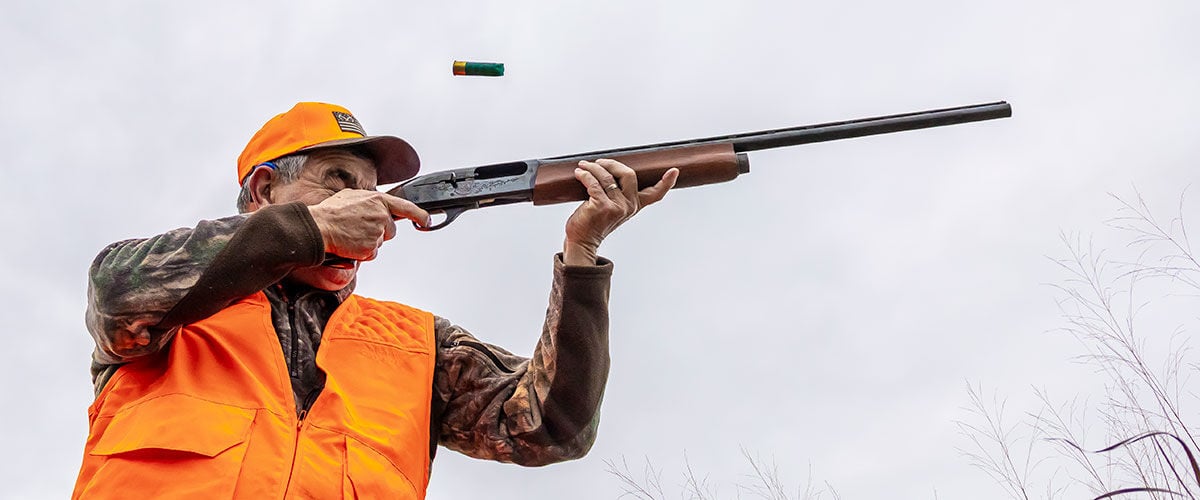 hunter shooting shotgun